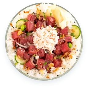 Top-down view of a poke bowl with cubed raw tuna, white rice, shredded crab salad, cucumber slices, edamame, and pickled ginger in a clear glass bowl against a black background.