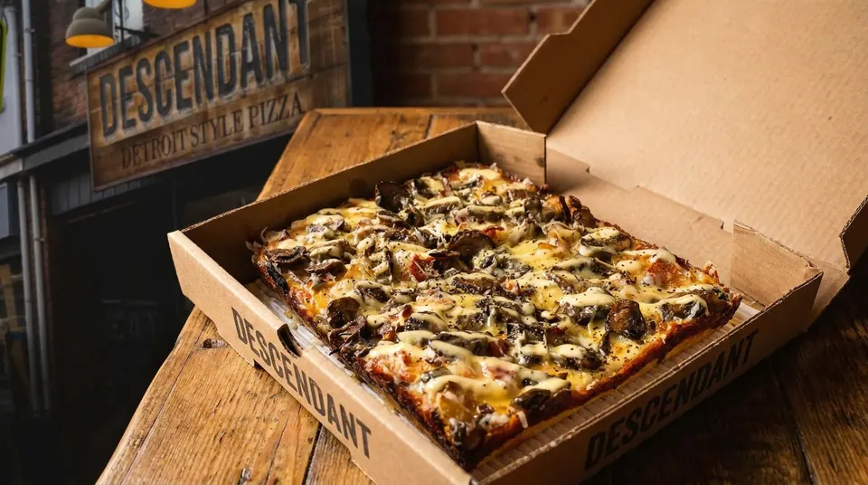 Freshly baked Detroit-style pizza in a box at Descendant Detroit Style Pizza.