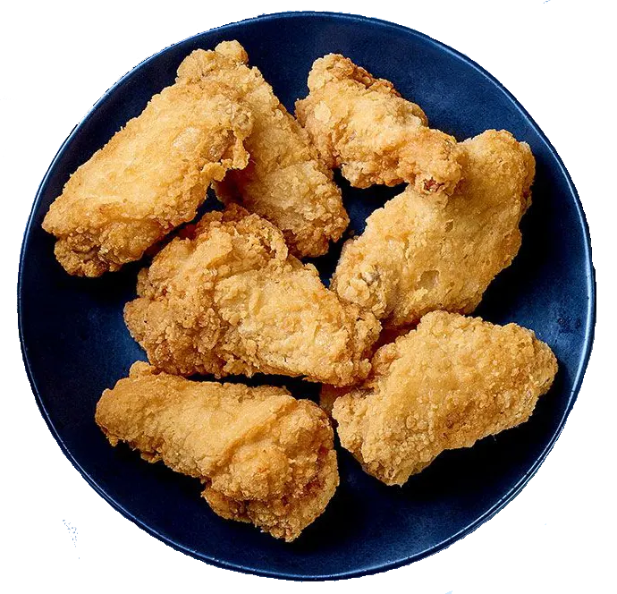 A top-down view of seven golden-brown, crispy fried chicken wings arranged on a dark blue ceramic plate against a black background.